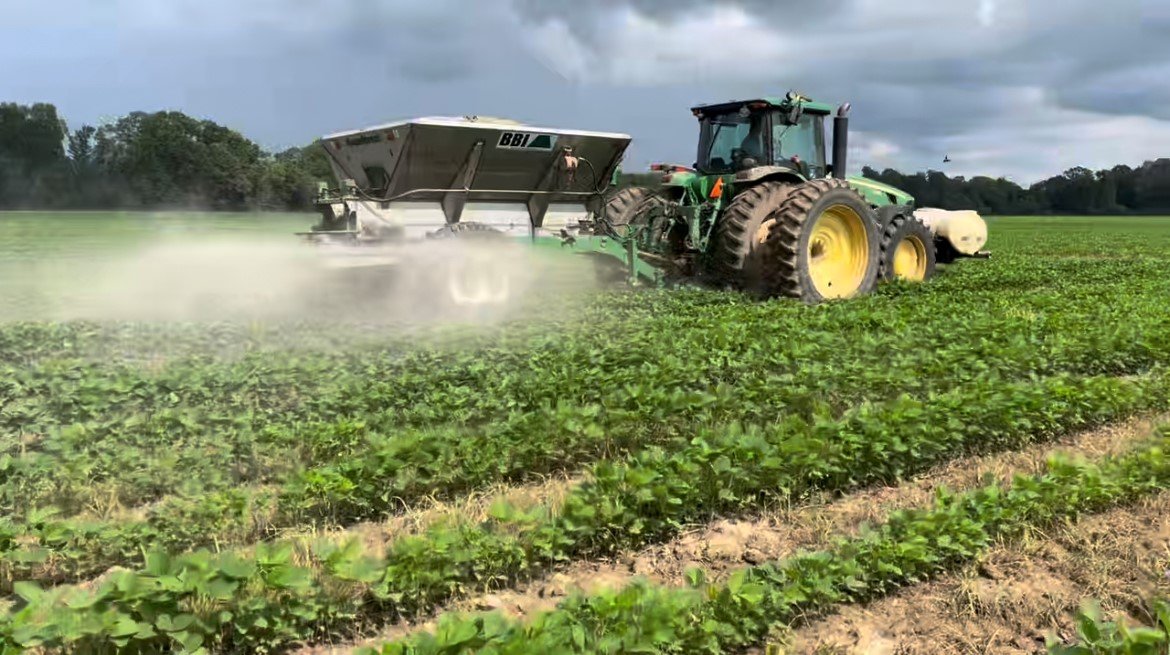Agricultural machinery applying pulverized minerals on farmland as part of Eion's enhanced rock weathering process for carbon dioxide removal.